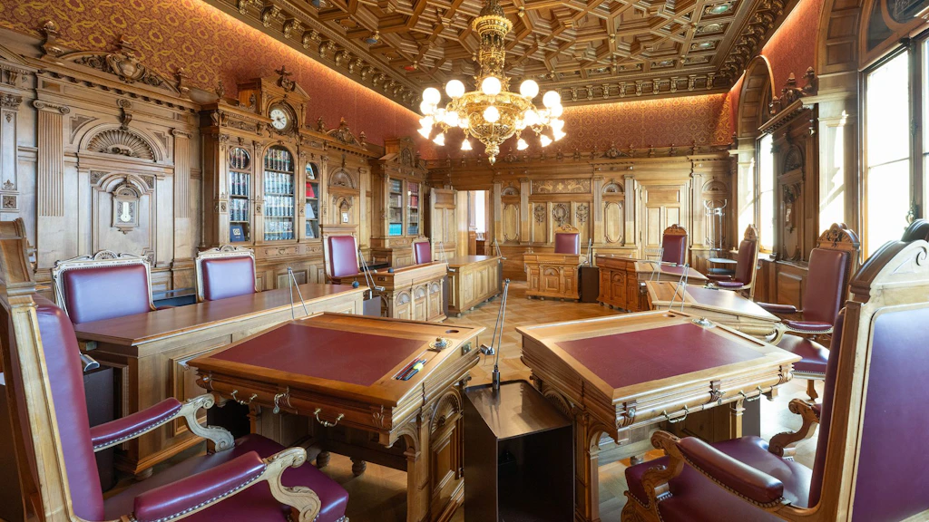 Sitzungszimmer des Bundesrats in historischem Altbau mit Holzverkleidung und roten Stühlen